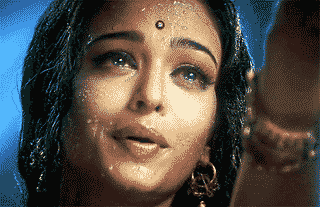 A woman expresses deep emotion amidst a rain-soaked scene.