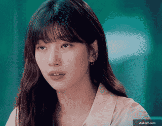 A young woman looks thoughtfully in a serene environment.